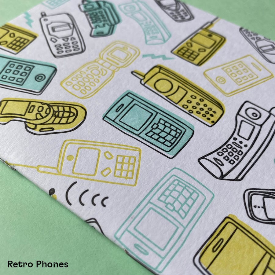 Close up of retro phones cover on letterpress pocket notebook